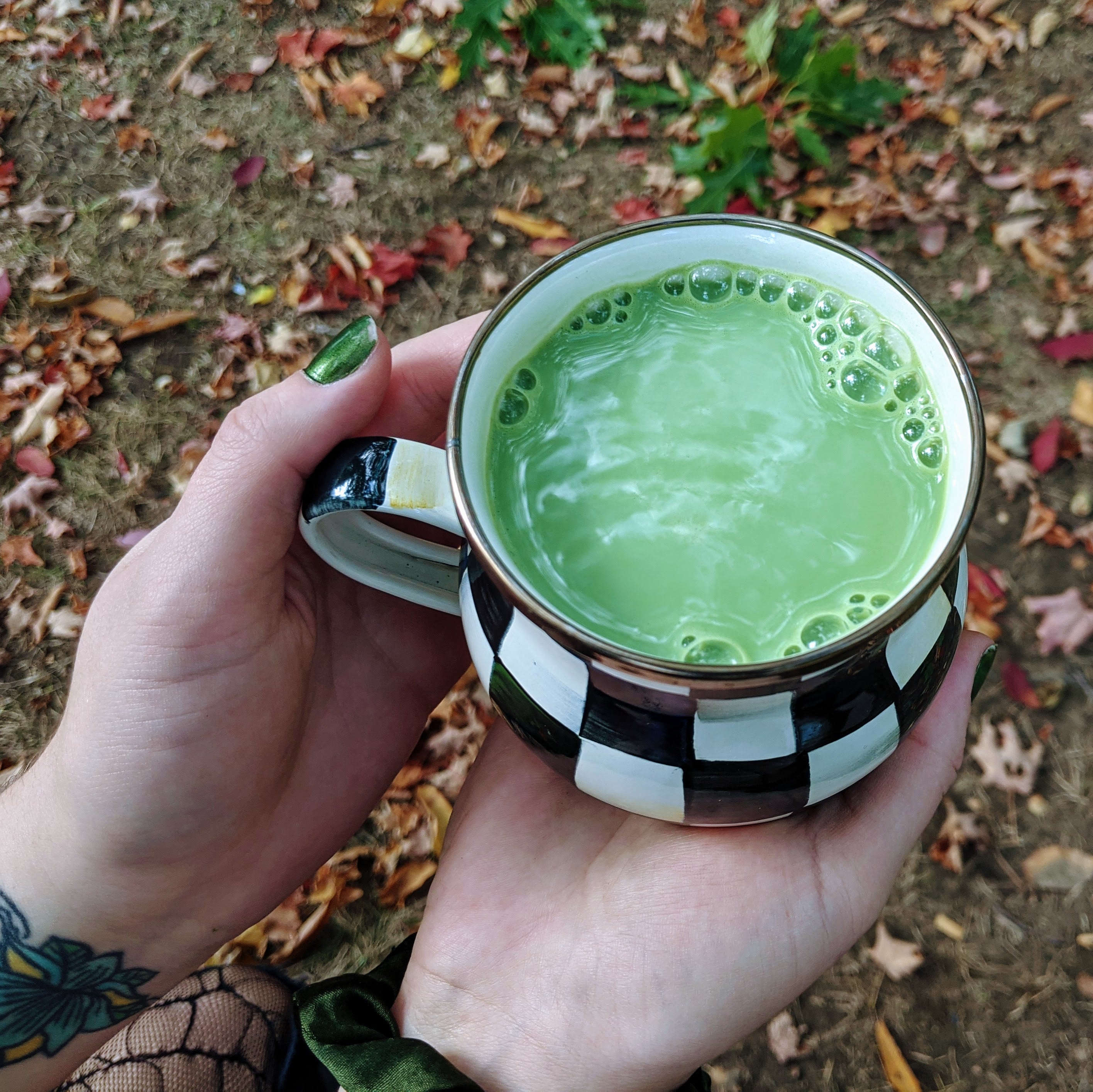 person holding matcha in a mug
