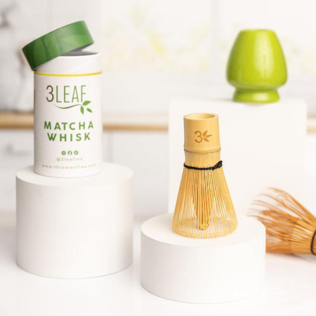 Bamboo matcha whisk displayed alongside its decorative container