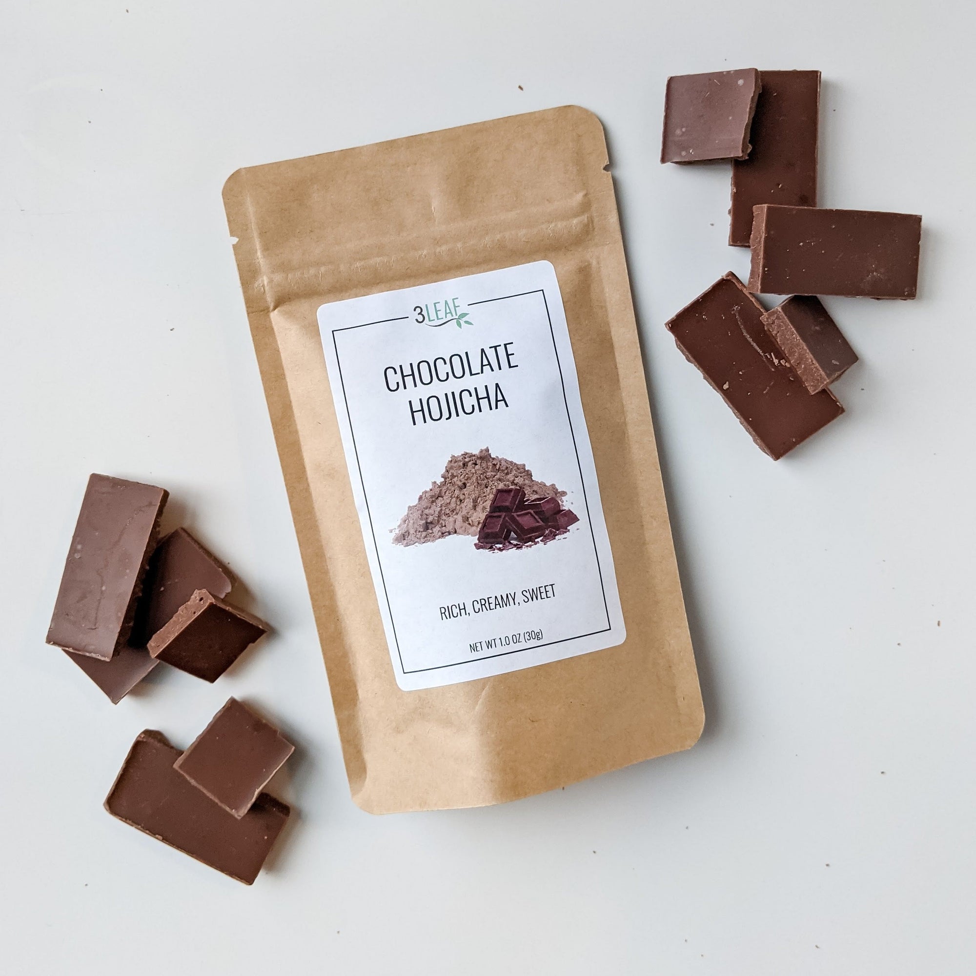 Chocolate Hojicha Bag surrounded by pieces of chocolate